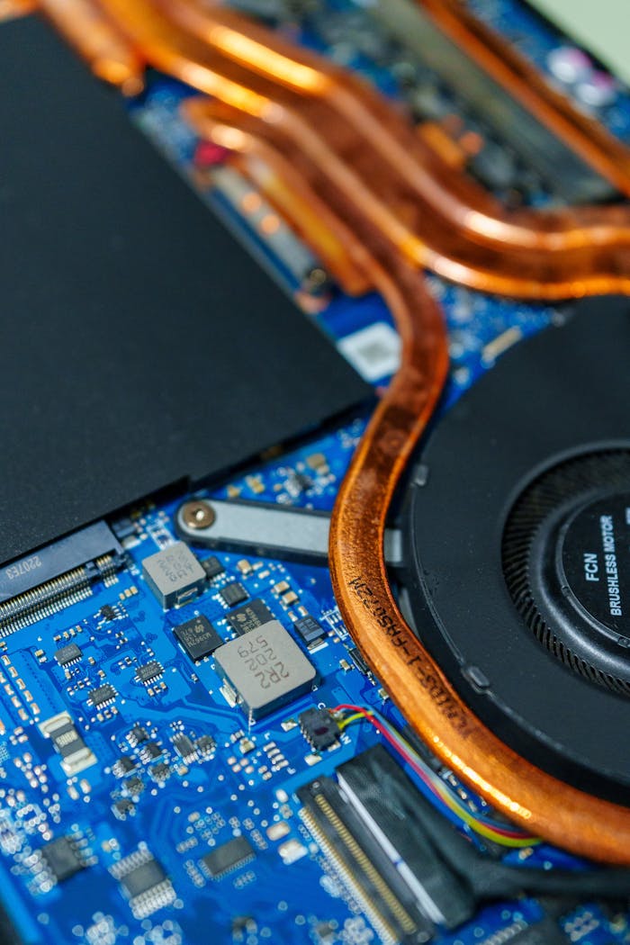 Detailed view of a computer motherboard showcasing heat pipes and internal circuitry.